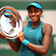 Cori “Coco” Gauff celebrates victory with the trophy following the girls’ singles final against Caty McNally uring day 14 of the 2018 French Open on June 9, 2018, in Paris.